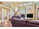 Elegant living room featuring a fireplace, high ceilings, and hardwood floors at 23029 Cleveland Dr, Parker, CO 80138