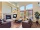 Cozy living room boasting a fireplace, hardwood floors, and large windows at 23029 Cleveland Dr, Parker, CO 80138