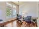 Bright living room with high ceilings, large windows, hardwood floors, and comfortable seating arrangement at 23029 Cleveland Dr, Parker, CO 80138