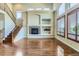 Bright living room featuring a fireplace, vaulted ceilings, and large windows with plantation shutters at 23029 Cleveland Dr, Parker, CO 80138