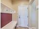 Functional mudroom with built-in bench, coat hooks, and an exterior door at 23029 Cleveland Dr, Parker, CO 80138