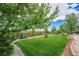 Well-manicured backyard with a lush lawn, beautiful landscaping, and privacy fence at 7522 S Mount Zirkel, Littleton, CO 80127