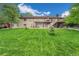 Expansive backyard featuring lush lawn, mature trees, patio, upper deck, and walkout basement access at 7522 S Mount Zirkel, Littleton, CO 80127