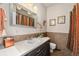 Well lit bathroom with dark cabinets and tile backsplash at 7522 S Mount Zirkel, Littleton, CO 80127