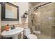Bathroom with shower stall with glass doors and pedestal sink at 7522 S Mount Zirkel, Littleton, CO 80127
