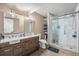 Updated bathroom with a double vanity, modern fixtures, and a glass-enclosed shower at 7522 S Mount Zirkel, Littleton, CO 80127