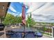 Outdoor deck space with a patio table, chairs, and umbrella perfect for entertaining with scenic views at 7522 S Mount Zirkel, Littleton, CO 80127