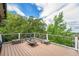 Spacious wooden deck featuring a fire pit with seating, ideal for outdoor relaxation and enjoying the surrounding nature at 7522 S Mount Zirkel, Littleton, CO 80127