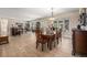 Bright dining room with hardwood floors, table with seating for eight, and large windows at 7522 S Mount Zirkel, Littleton, CO 80127