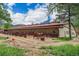 Equestrian facility with horse stalls, dirt paddocks, and a rustic barn-style building at 7522 S Mount Zirkel, Littleton, CO 80127