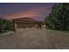The exterior of this house boasts a spacious three-car garage, set against the backdrop of a striking sunset at 7522 S Mount Zirkel, Littleton, CO 80127