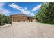 The exterior of this house boasts a spacious three-car garage, set against the backdrop of a blue sky at 7522 S Mount Zirkel, Littleton, CO 80127