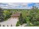 Aerial view of a home with a three-car garage, mature trees, professional landscaping, and neighborhood views at 7522 S Mount Zirkel, Littleton, CO 80127