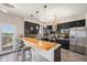 Stylish kitchen with stainless steel appliances, breakfast bar, and access to an outdoor deck at 7522 S Mount Zirkel, Littleton, CO 80127