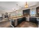 Open kitchen with stone backsplash, breakfast bar, granite countertops, and stainless steel appliances at 7522 S Mount Zirkel, Littleton, CO 80127