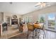 Bright living area featuring a cozy fireplace, ceiling fan, and access to outdoor seating at 7522 S Mount Zirkel, Littleton, CO 80127