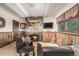 Cozy living room with a stone fireplace and rustic wood paneling at 7522 S Mount Zirkel, Littleton, CO 80127