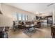 Comfortable living room with a large sectional sofa, hardwood floors, and kitchen access, perfect for relaxation and entertaining at 7522 S Mount Zirkel, Littleton, CO 80127