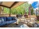 Inviting covered patio with a cozy outdoor seating area and a stone fireplace, perfect for relaxation and entertaining at 7522 S Mount Zirkel, Littleton, CO 80127
