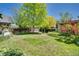 Green backyard features a spacious lawn and established garden beds at 2236 Forest St, Denver, CO 80207