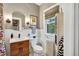 Bright bathroom features a window, wood vanity, and white wainscoting detail at 2236 Forest St, Denver, CO 80207