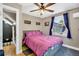 Cozy bedroom features a comfortable bed, ceiling fan, and bright window views at 2236 Forest St, Denver, CO 80207