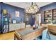 Sophisticated dining room showcasing a stylish buffet, dark blue walls, and a modern lighting fixture at 2236 Forest St, Denver, CO 80207