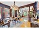 Stunning dining room featuring beautiful hardwood floors, a modern chandelier, and an open layout at 2236 Forest St, Denver, CO 80207