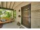 Inviting front porch featuring a charming swing, brick accents, and a stylish front door with the house number displayed at 2236 Forest St, Denver, CO 80207