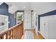 Hallway with hardwood floors and custom built-in cabinets offers convenient storage at 2236 Forest St, Denver, CO 80207