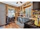 Rustic kitchen with brick wall, wood cabinets, stainless steel appliances, and lots of natural light at 2236 Forest St, Denver, CO 80207