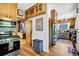 Charming kitchen featuring wood cabinets, stainless steel appliances, and an inviting doorway to other rooms at 2236 Forest St, Denver, CO 80207