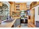 Charming kitchen featuring wood cabinets, stainless steel appliances, and an inviting doorway to other rooms at 2236 Forest St, Denver, CO 80207