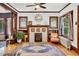 Cozy living room with a decorative fireplace, stained glass windows, built-in bookshelves, hardwood floors, and an accent rug at 2236 Forest St, Denver, CO 80207