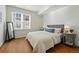Serene bedroom with a comfortable bed, neutral decor, and a large window providing natural light at 12924 Ironstone Way # 103, Parker, CO 80134
