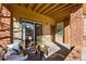Covered patio with seating area located by sliding glass door to unit #103 at 12924 Ironstone Way # 103, Parker, CO 80134