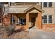 Building entrance features cozy seating area with brick pillars at 12924 Ironstone Way # 103, Parker, CO 80134