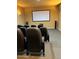 A home theater room featuring tiered seating, speakers, and a large projection screen for an immersive movie experience at 12924 Ironstone Way # 103, Parker, CO 80134