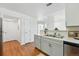 Well-lit kitchen with stainless steel appliances, gray cabinets, and convenient access to other areas at 12924 Ironstone Way # 103, Parker, CO 80134