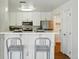 Charming kitchen showcasing stainless steel appliances and a stylish breakfast bar with seating at 12924 Ironstone Way # 103, Parker, CO 80134