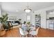 Cozy living room with dining area featuring modern furnishings, wood floors, and ample natural light at 12924 Ironstone Way # 103, Parker, CO 80134