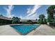 Community pool and lounge area with trees in the background at 12924 Ironstone Way # 103, Parker, CO 80134
