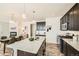 Open-concept kitchen featuring stainless steel appliances, a spacious island, and a dining area at 11225 Colony Cir, Broomfield, CO 80021