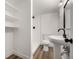 Clean bathroom with toilet, sink, shower, and shelving at 3012 S Jericho Way, Aurora, CO 80013