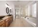 Elegant bathroom with double vanity and soaking tub at 3012 S Jericho Way, Aurora, CO 80013
