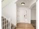 Bright entryway with hardwood floors, staircase, and coat closet at 3012 S Jericho Way, Aurora, CO 80013
