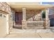 Front entrance with steps leading to a covered porch at 3012 S Jericho Way, Aurora, CO 80013