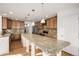Kitchen with granite countertops, wooden cabinets, and island at 3012 S Jericho Way, Aurora, CO 80013