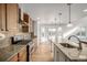 Bright kitchen with an island, wood cabinets, and granite counters at 3012 S Jericho Way, Aurora, CO 80013