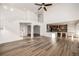 Open concept living room with kitchen island and hardwood floors at 3012 S Jericho Way, Aurora, CO 80013